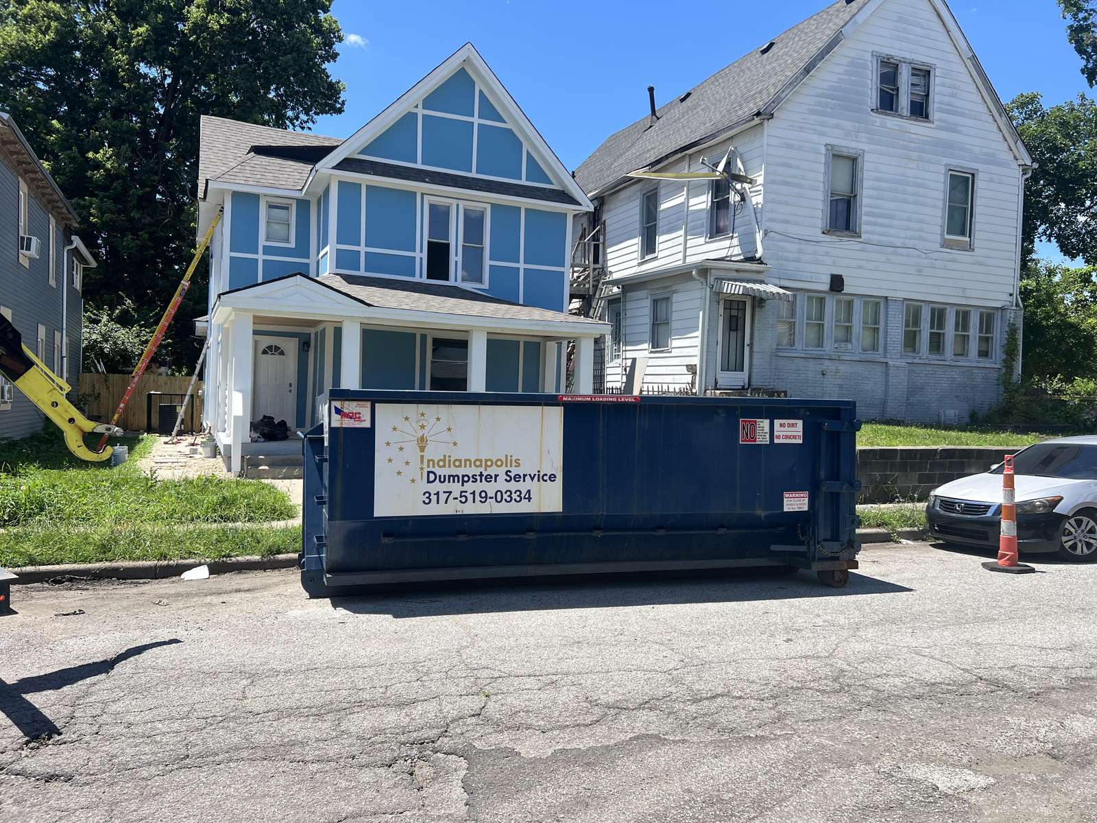 A navy Indianapolis Dumpster Service roll off container in Indianapolis. A remodel with the front of the house opened up.